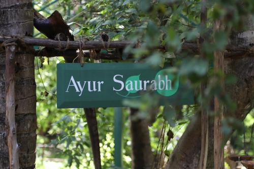 a green street sign that reads ayur santatalotin at Cure Monastery Family Resort in Marayoor
