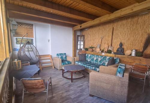 a living room with a blue couch and chairs at Pension Maintal Eltmann in Eltmann