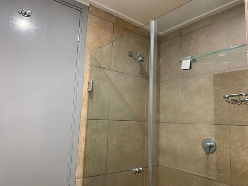 a bathroom with a shower with a glass door at 307 Point Bay in Durban