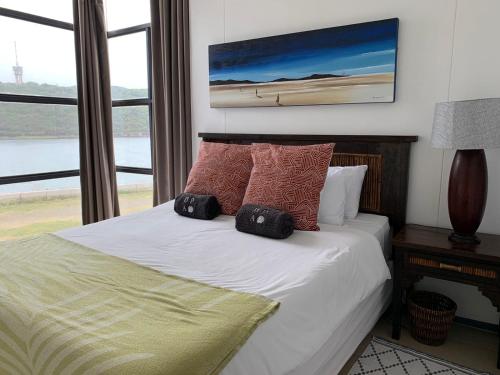 a bedroom with a bed with pillows on it at 307 Point Bay in Durban