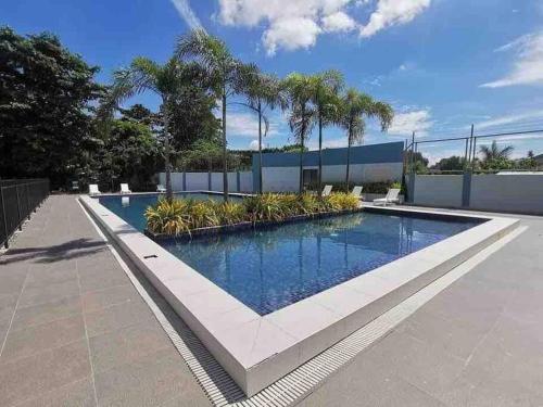 a swimming pool in the middle of a house at Lovely Studio Type Condo - fully furnished in Mactan