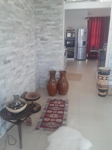 two large vases sitting on the floor in a kitchen at Unik studio Apartments in Lusaka