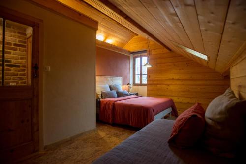 a attic room with two beds and a window at Le Rêve d'Aghon Chambres et Table d'Hôtes in Bagnères-de-Bigorre