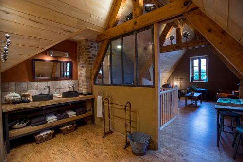 an attic kitchen with a large door in a house at Le R&ecirc;ve d'Aghon Chambres et Table d'H&ocirc;tes in Bagn&egrave;res-de-Bigorre