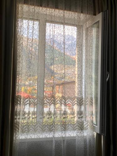 a window with a view of a city at Guest house chavchavadze N23 in Stepantsminda