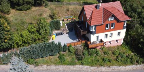 an aerial view of a house with a red roof at FaFeWo Ferienwohnungen mit Sternekomfort in Tanne Harz in Tanne