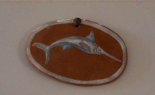 a mirror with a picture of a dolphin on a wall at Giuggiulena in Siracusa