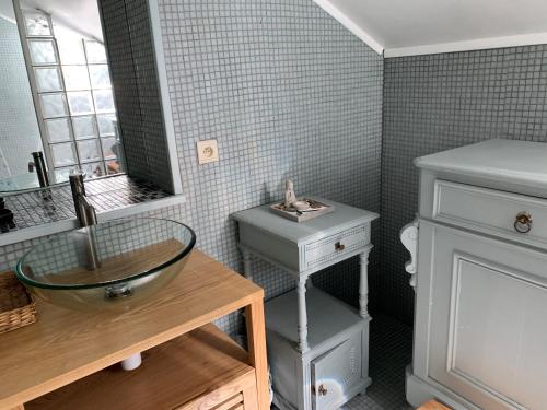 a bathroom with a sink and a mirror and a counter at Maison de Rochehaut in Rochehaut