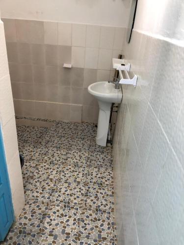 a bathroom with a sink and a toilet at OCEAN-SI Mansion in Kribi