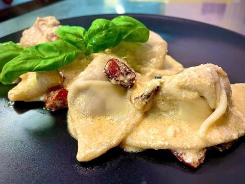 a blue plate with some food on top at Hotel Cala Luna in Cala Gonone