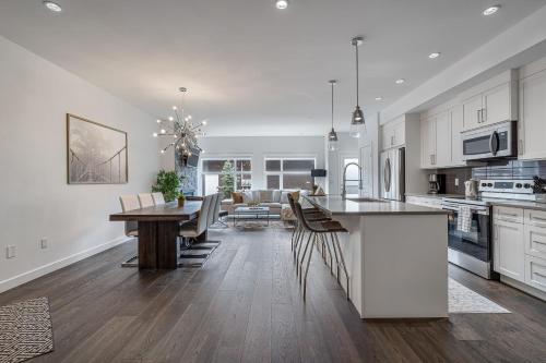 a kitchen and dining room with a table and chairs at Contemporary Luxury 4 bedroom House near Downtown in Calgary