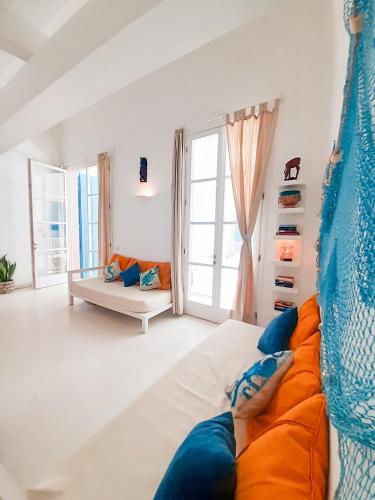 a living room with a bed and a couch at App Rosanna, Estoril Beach, 2steps from the sea, Free Wi-Fi & AC in Sal Rei