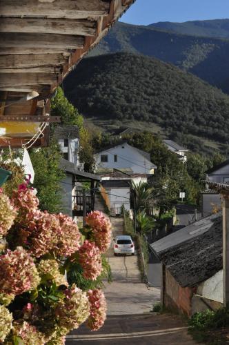 a small town with a car driving down a street at Ollar do Cido in Seoane