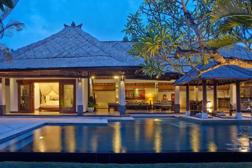 an exterior view of a villa with a swimming pool at The Maya Seminyak Villas in Seminyak