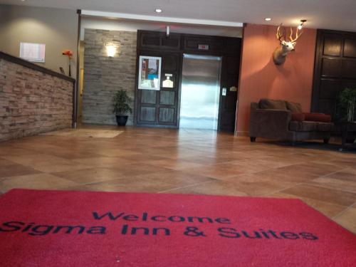 
a red carpeted room with a red carpet and a red carpet at Sigma Inn & Suites Hudson's Hope in Hudson Hope
