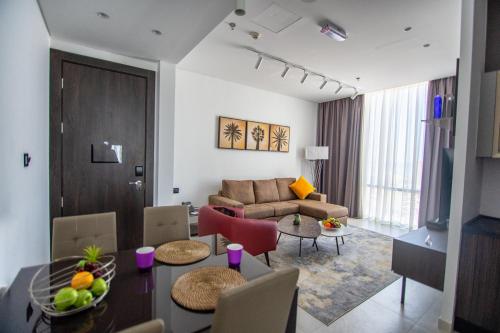a living room with a couch and a table at Swiss-Belinn Sharq, Kuwait in Kuwait