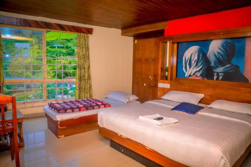 a bedroom with two beds and a window at Munnar Days in Munnar