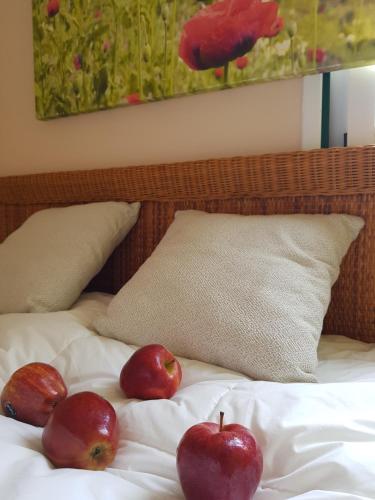 three apples sitting on top of a bed at THE POPPIES Guest House - 100m Ocean - Private Spaces in Candelaria