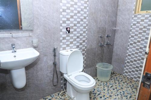 a bathroom with a toilet and a sink at Munnar Days in Munnar