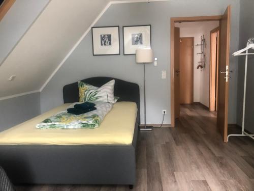 a bed sitting in a room with a staircase at Ferienwohnungen Margot in Iserlohn