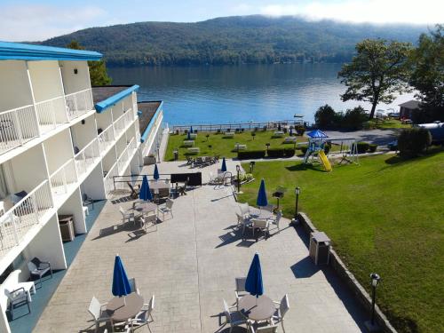 a balcony of a hotel with chairs and a playground at Lakefront Terrace Resort in Lake George
