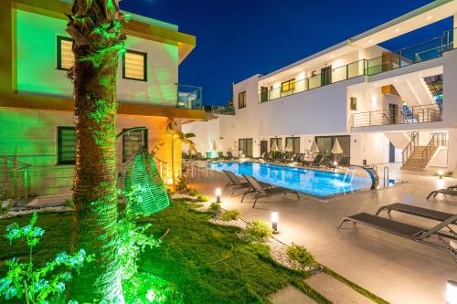 a villa with a swimming pool at night at Milenyum Residence in Bodrum City
