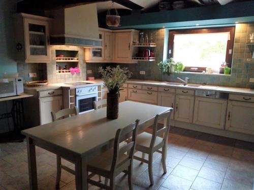 a kitchen with a table and chairs and a window at Le Relais du Malpas in Namur