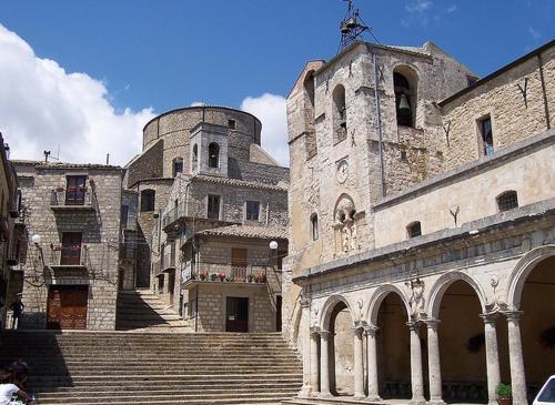 a large stone building with stairs in front of it at La Casa del Poeta , un romantico chalet da mille e una notte in Petralia Soprana
