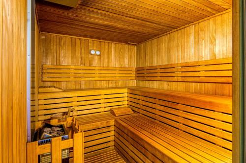 a large wooden sauna with wooden benches in a room at Hotel Le Torri in Arborea 