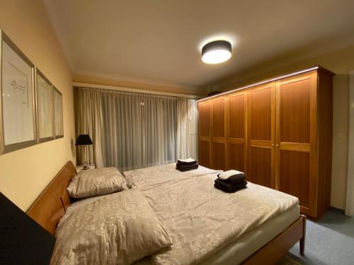 a bedroom with a bed with two bags on it at Chesa Derby 32 in St. Moritz