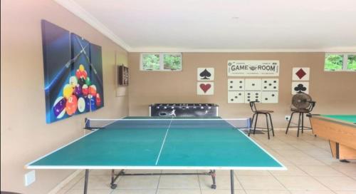 a ping pong table in a room at Hello Holiday at 4 Boboyi Mangrove Beach Estate in Port Shepstone