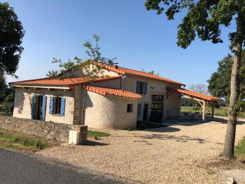 a small house with an orange roof on a street at LA BERGERIE DU DAMIAN in Neuville