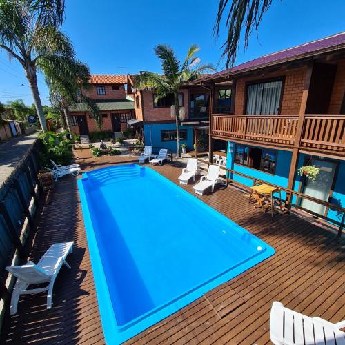 a swimming pool on the deck of a house at Pousada Doce Mar in Guarda do Embaú