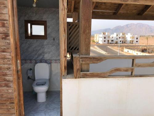 a bathroom with a toilet and a view of a city at Villa Boghdady Dahab in Dahab