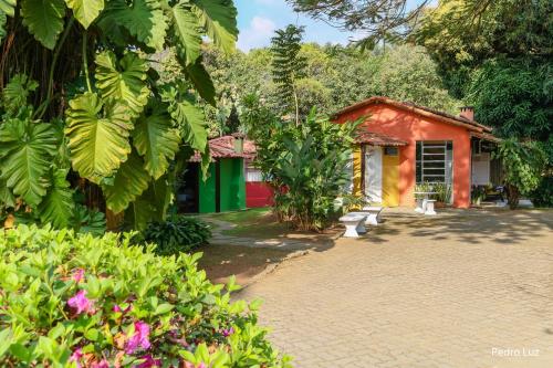 a house with a brick driveway in front of it at Pousada Villa Luna in Penedo