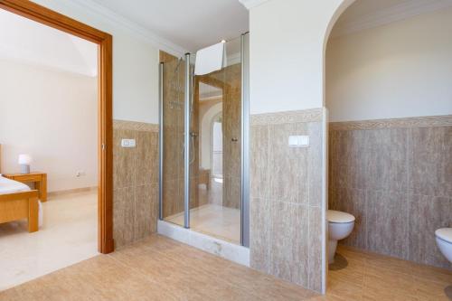 a bathroom with a shower and a toilet and a sink at Arcos Gardens Sol Rent Golf in Arcos de la Frontera