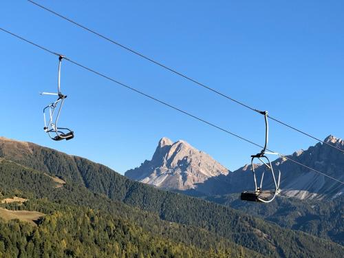a pair of chairs on a ski lift in the mountains at Haus Lasaun in Bressanone