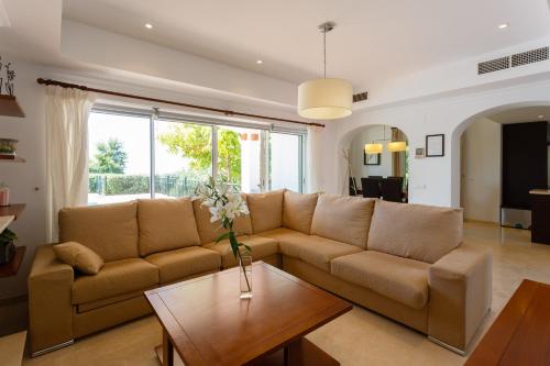 a living room with a couch and a table at Arcos Gardens Sol Rent Golf in Arcos de la Frontera
