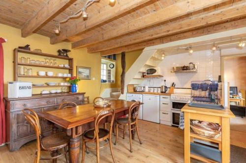 uma grande cozinha com uma mesa de madeira e cadeiras em The Cottage By The Sea, Scotland em Burnmouth