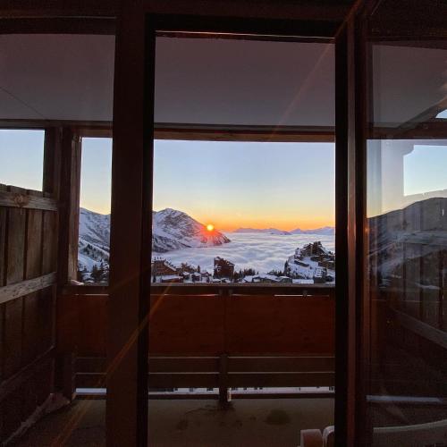 a view of a snowy mountain from a window at F2 résidence Antarès in Avoriaz