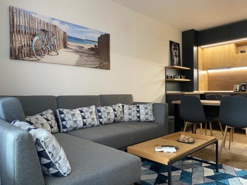 a living room with a couch and a table at Arletti Luxury Apartment in Ruse