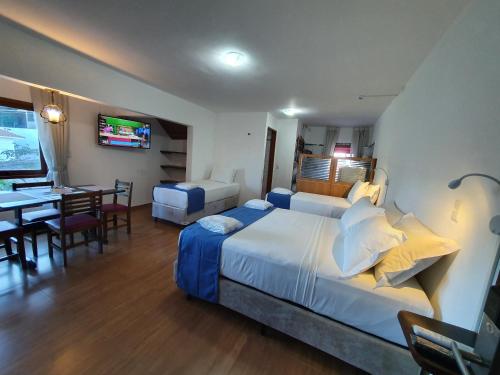 Ένα ή περισσότερα κρεβάτια σε δωμάτιο στο Hotel Chalet Monet - Granja Vianna