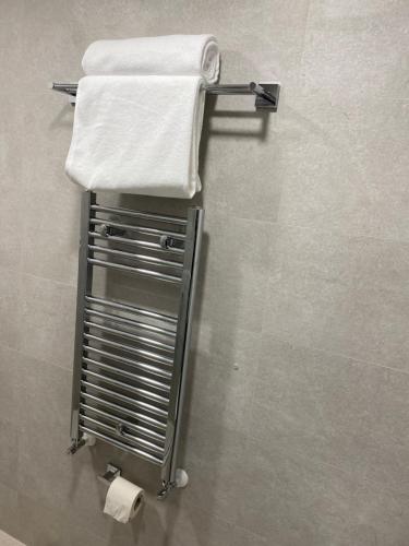 a towel rack with towels on it in a bathroom at Arletti Luxury Apartment in Ruse