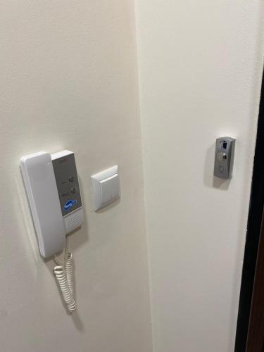 a phone is hanging on a wall in a room at Arletti Luxury Apartment in Ruse