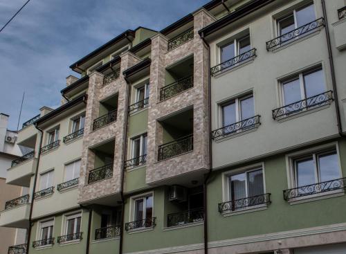 an apartment building with windows and balconies at Arletti Luxury Apartment in Ruse