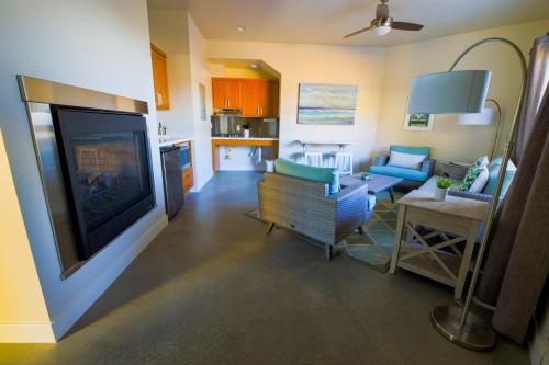 a living room with a large flat screen tv at Baywood Inn Bed & Breakfast in Los Osos