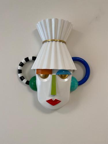 a statue of a clown with a hat on a wall at Arletti Luxury Apartment in Ruse