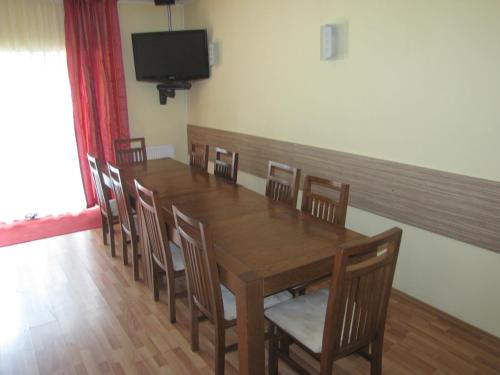 a dining room with a wooden table and chairs at Vila Amira Predeal in Predeal