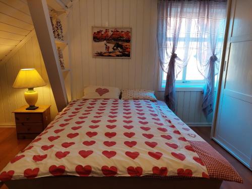 a bedroom with a bed with red hearts on it at Egil's Vacation House in Lillehammer