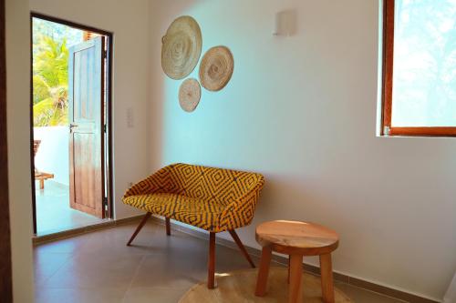 a living room with a chair and a table at Kijani Beach Villas in Bwejuu